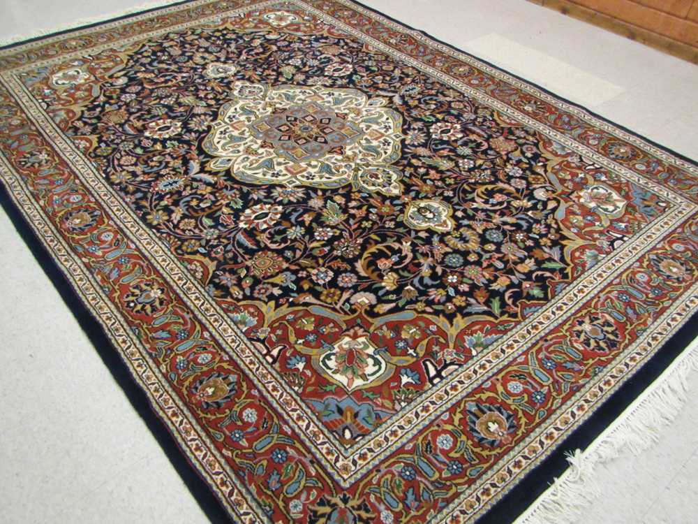 Appraisal: HAND KNOTTED ORIENTAL CARPET Indo-Persian floral and central floral medallion