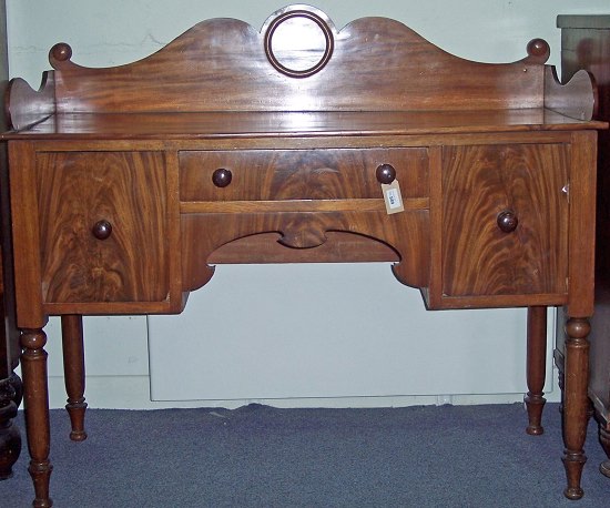 Appraisal: A Regency mahogany kneehole sideboard with shaped solid three-quarter gallery