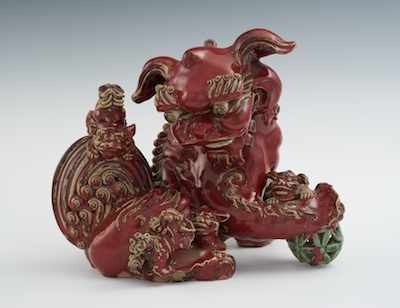 Appraisal: A Large Glazed Earthenware Foo Lion with Cubs In a