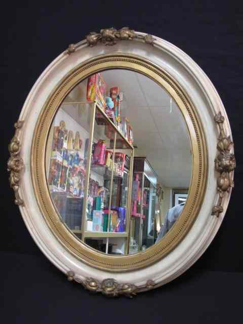 Appraisal: Oval wall mirror with floral motif Off white finished wood