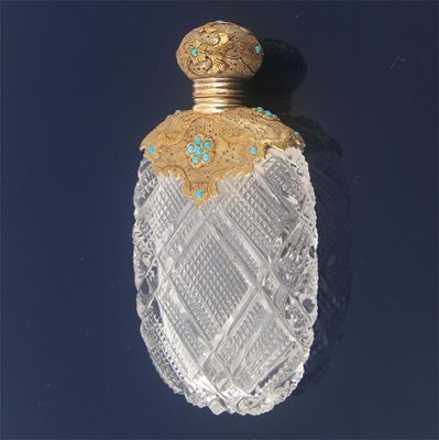 Appraisal: A th century gold mounted carved glass scent bottle the