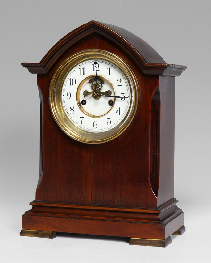 Appraisal: WATERBURY MANTLE CLOCK Architectural wood case with brass feet Porcelain