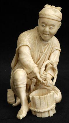 Appraisal: JAPANESE CARVED IVORY OKIMONO Carved as a seated bare-foot youth