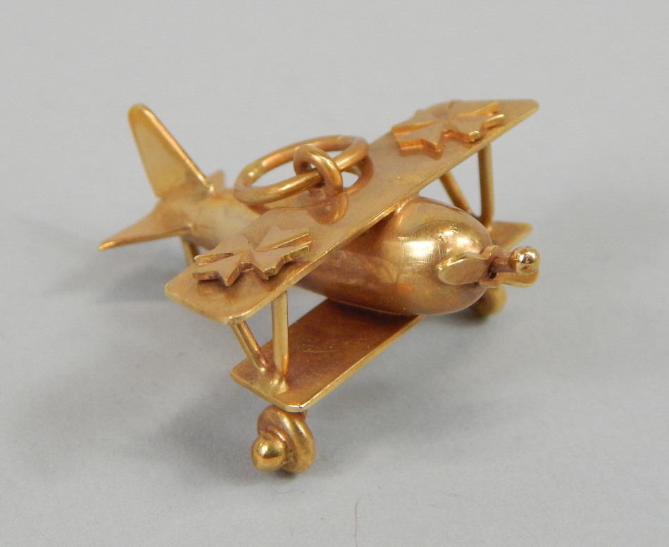 Appraisal: A ct gold bi-plane charm or pendant the plane with