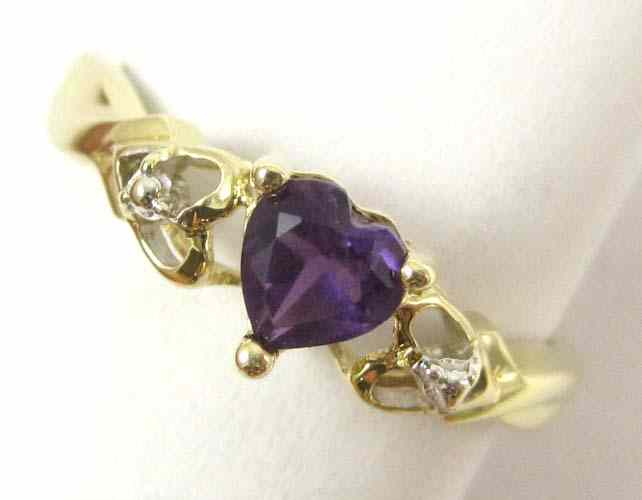 Appraisal: AMETHYST AND TEN KARAT YELLOW GOLD RING set with a