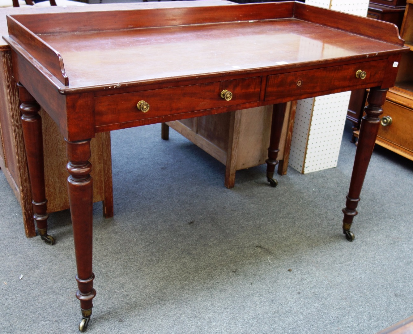 Appraisal: An early Victorian mahogany washstand the three quartered galleried top