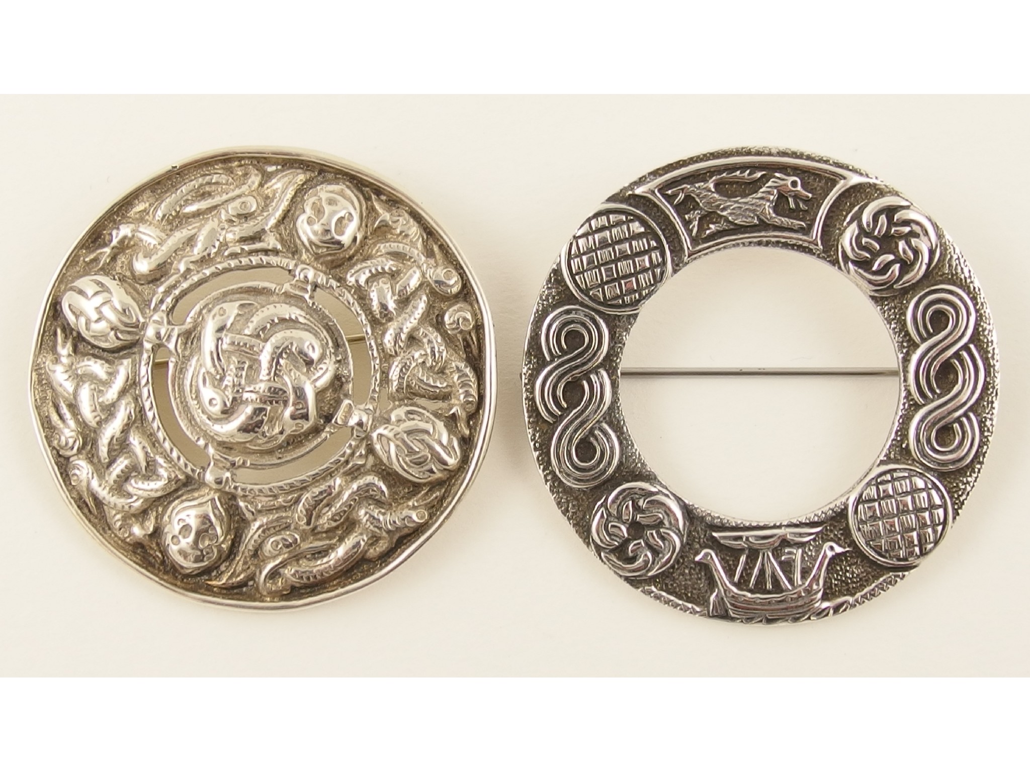 Appraisal: A silver Robert Allison circular brooch with Viking motifs together