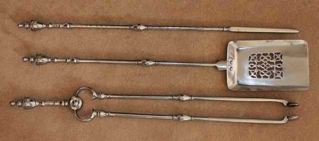 Appraisal: A SET OF TH CENTURY POLISHED STEEL FIRE IRONS with