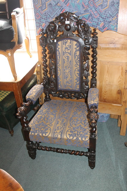 Appraisal: A HIGH BACK PADDED ARMCHAIR in dark oak with barley