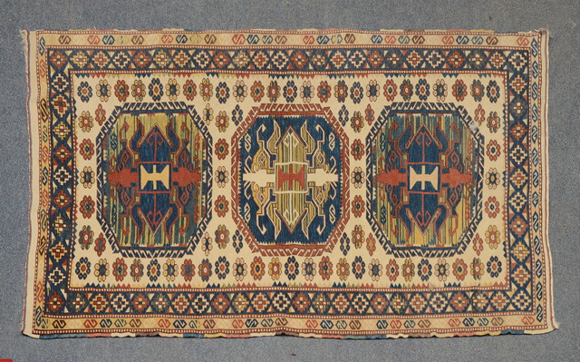 Appraisal: A TURKISH POLYCHROME RUG with three central octagonal medallions within