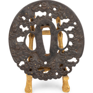 Appraisal: A Japanese Iron Tsuba th Century with gilt metal stand