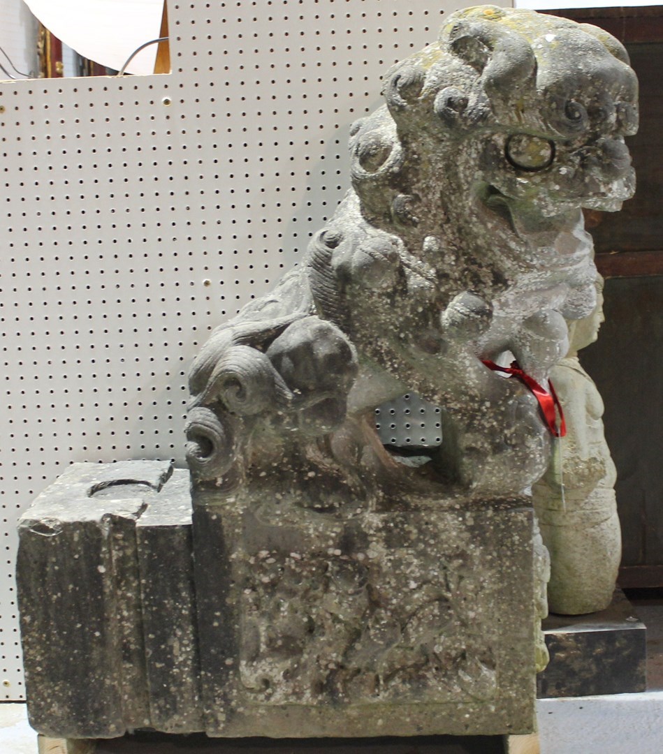 Appraisal: A pair of granite door jambs relief carved with seated