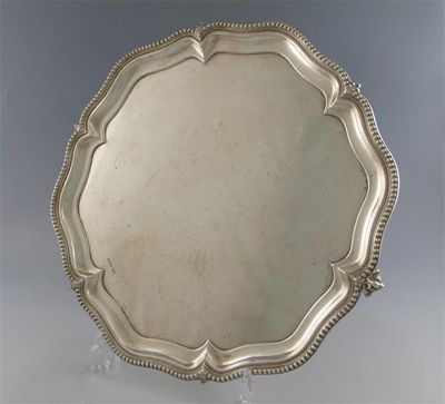 Appraisal: A modern salver of shaped outline with bead borders on