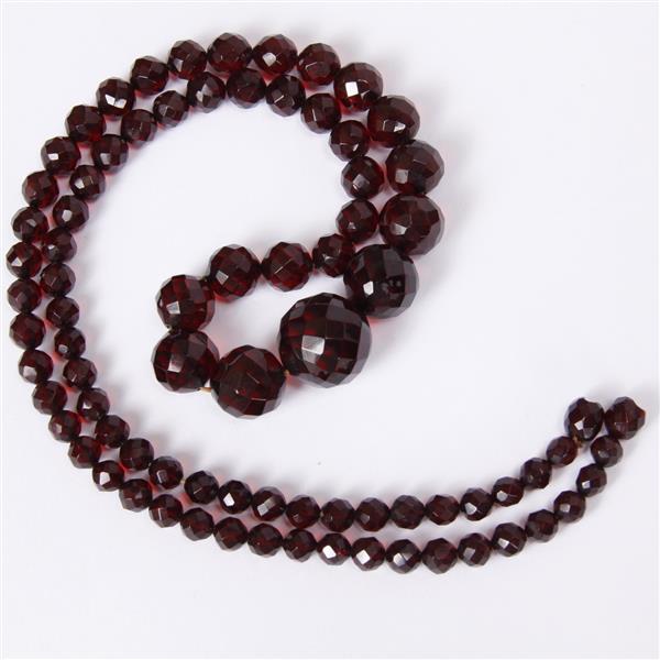 Appraisal: Strand of faceted graduated red amber beaded necklace with BROKEN