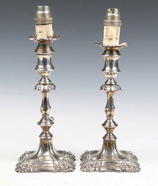 Appraisal: A PAIR OF SILVER CANDLESTICKS standing on square stepped bases