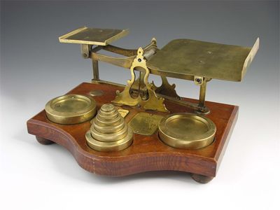 Appraisal: A set of brass postal scales mounted on an oak