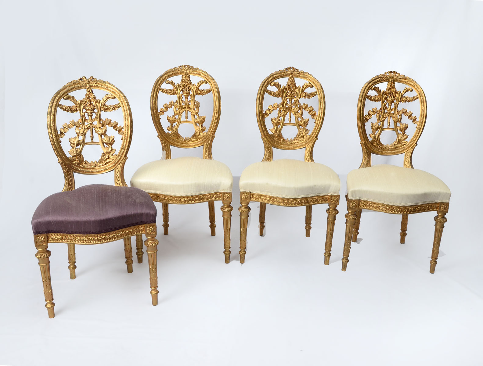 Appraisal: CARVED SALON CHAIRS Parlor chairs having a Gilt scrolling foliate