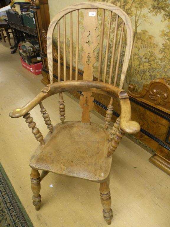 Appraisal: A Windsor open armchair with a solid seat on turned