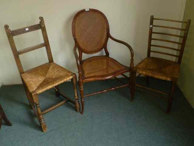 Appraisal: A VICTORIAN MAHOGANY OPEN ARMCHAIR with cane seat and back