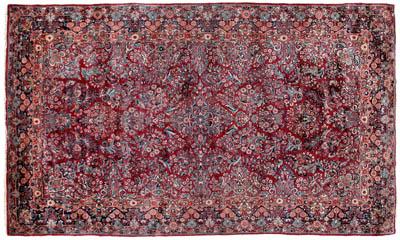 Appraisal: Sarouk rug repeating floral designs on burgundy red field ft