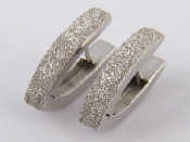 Appraisal: A pair of white metal tests carat gold bright cut