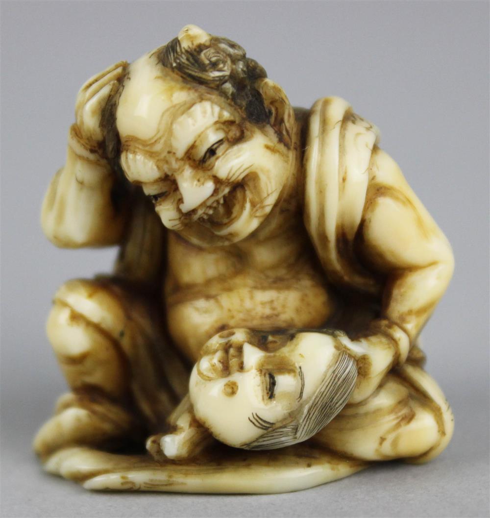 Appraisal: IVORY NETSUKE OF ONI SEATED ON A FAN AND GAZING