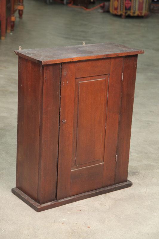 Appraisal: HANGING CUPBOARD Walnut with a single paneled door and three