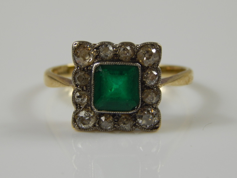 Appraisal: An ct gold dress ring with central green stone surrounded