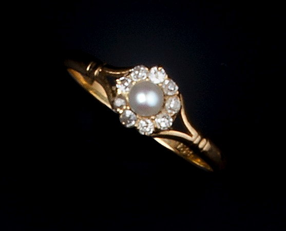 Appraisal: A HALF PEARL AND DIAMOND CLUSTER RING the central half