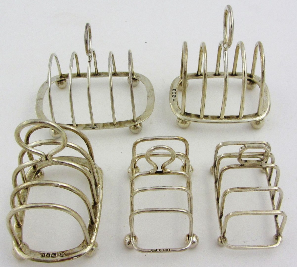 Appraisal: Silver comprising a pair of five bar toastracks each of