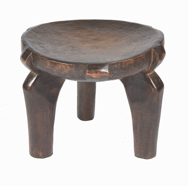 Appraisal: A SMALL TRIBAL HARDWOOD STOOL on three stylised supports