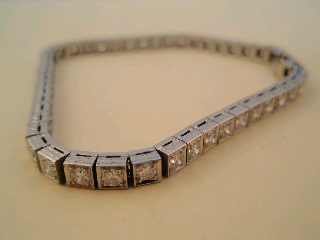 Appraisal: A diamond set tennis bracelet of forty eight diamonds totalling