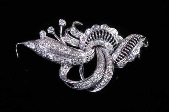 Appraisal: PLATINUM AND DIAMOND SCROLL-AND-LEAF DESIGN BROOCH Numerous round diamonds together