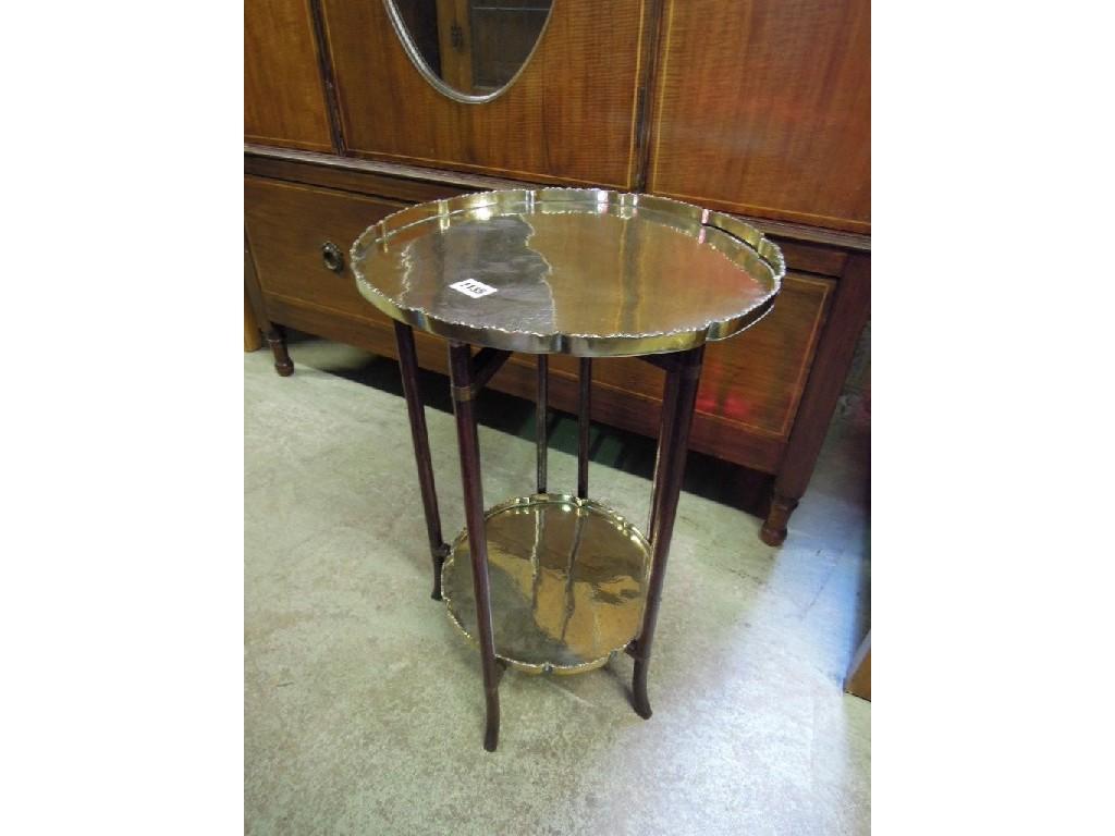 Appraisal: An eastern polished brass -tier occasional table with engraved trailing