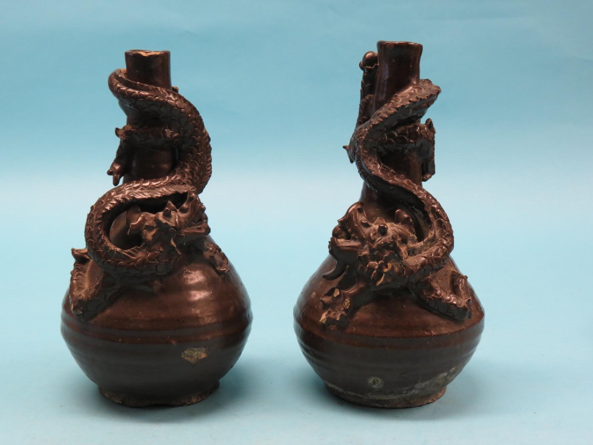 Appraisal: A pair of Chinese brown-glazed stoneware vases globe-and-shaft form modelled