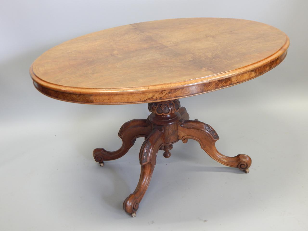 Appraisal: A Victorian walnut oval breakfast table the top with moulded