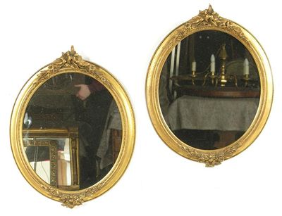 Appraisal: A pair of oval giltwood and gesso wall mirrors in