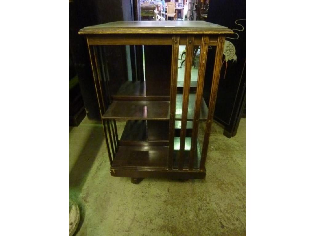 Appraisal: An Edwardian walnut revolving bookcase of usual square cut form