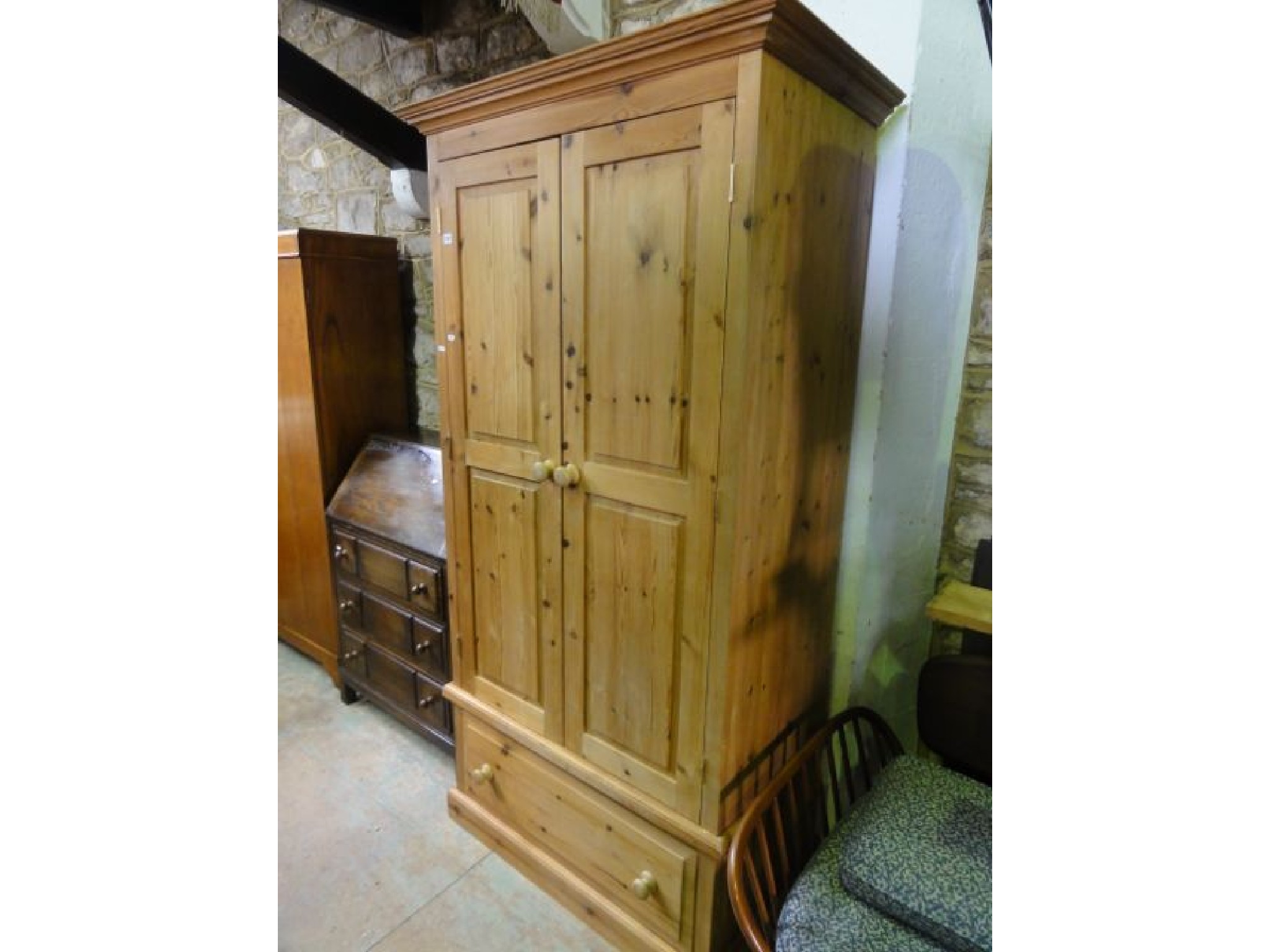 Appraisal: A stripped pine wardrobe with moulded cornice over a pair