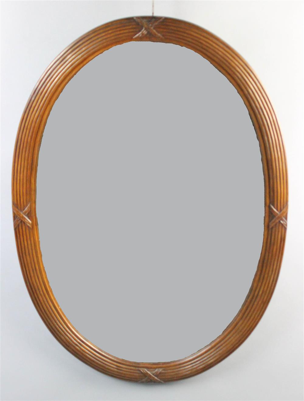 Appraisal: CLASSICAL STYLE MAHOGANY OVAL MIRROR the reeded frame carved with