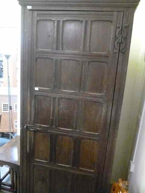 Appraisal: AN OAK CUPBOARD the fielded panelled sides and similar single