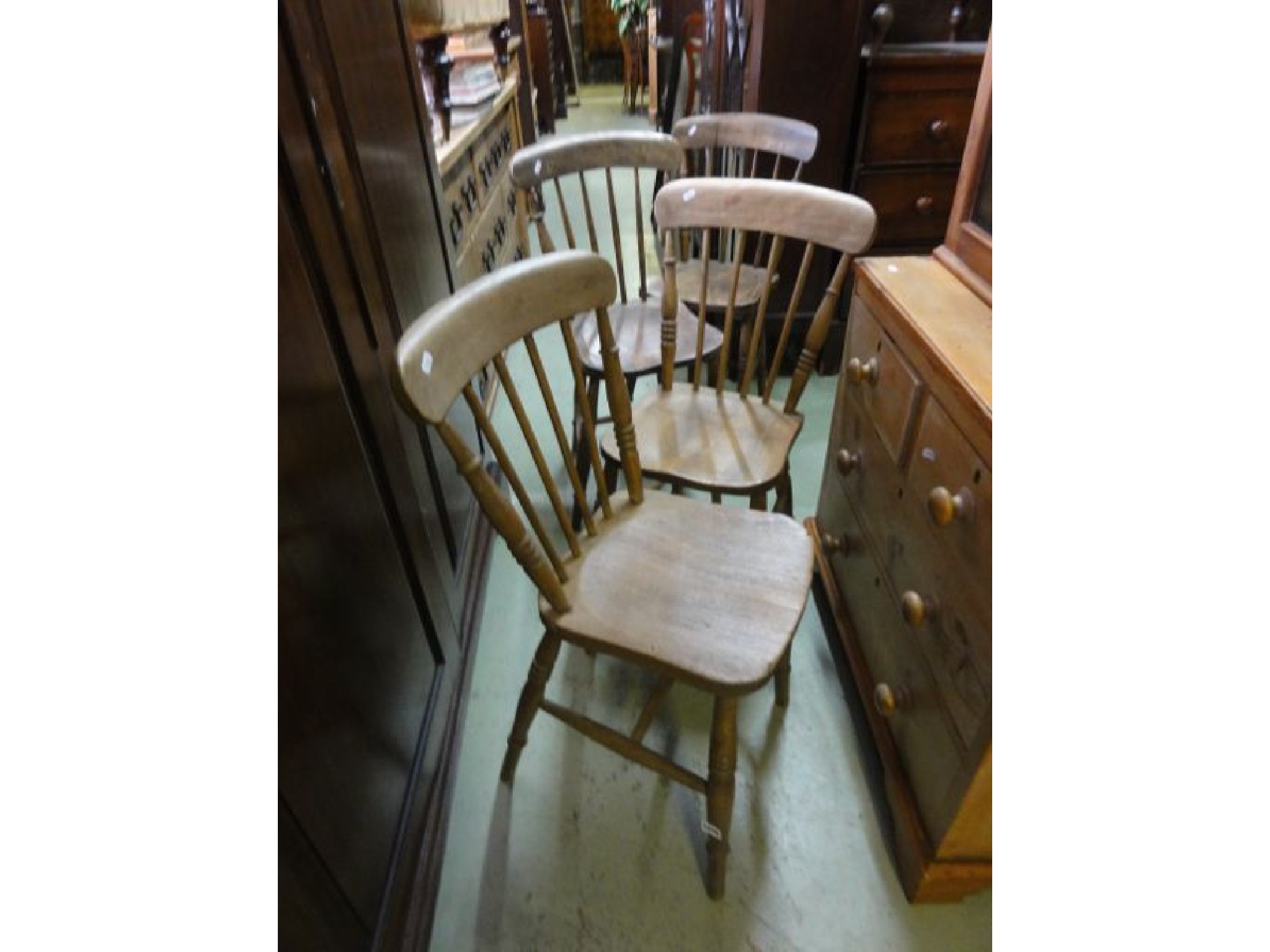 Appraisal: A set of four elm and beechwood stickback kitchen chairs