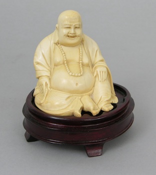 Appraisal: A Carved Ivory Figurine of Buddha The figurine is of