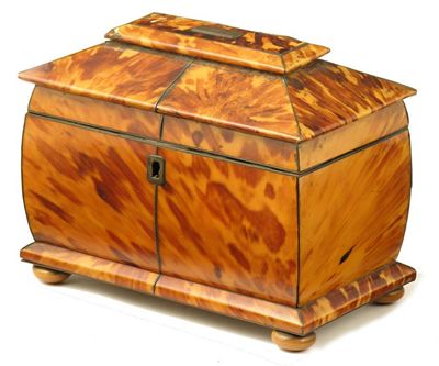 Appraisal: A Regency tortoiseshell tea caddy with pewter stringing and horn