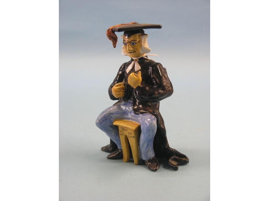 Appraisal: A Mosanic earthenware figure seated schoolmaster painted in polychrome in