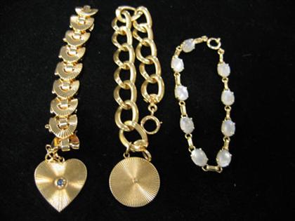 Appraisal: Three gold bracelets Two with thicker chains and larger charms