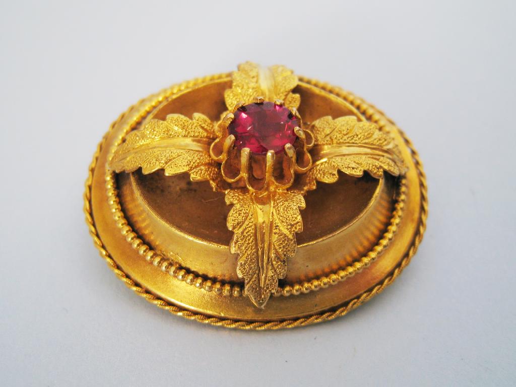 Appraisal: A Victorian Ruby Brooch the circular-cut stone claw-set amidst four