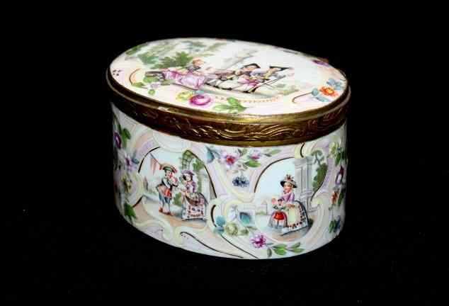 Appraisal: AN OVAL ENAMEL AND GILT METAL BOX with hinged lid