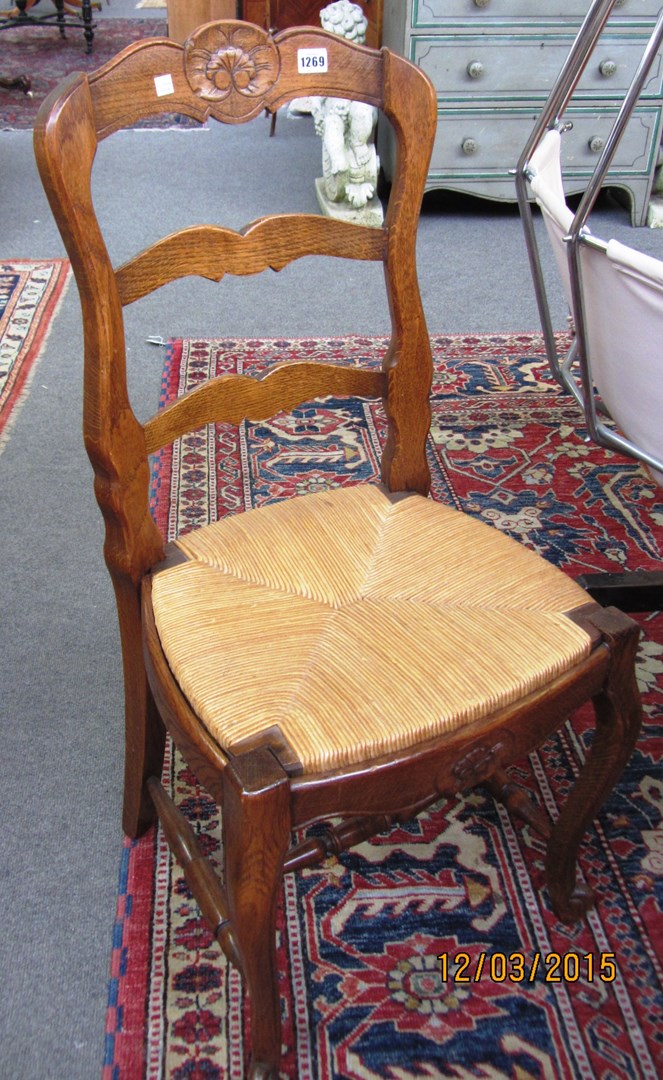 Appraisal: A set of six French stained beech ladder back chairs