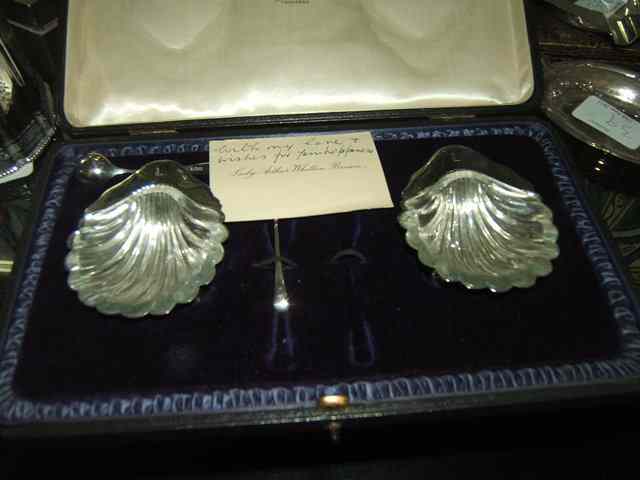 Appraisal: A CASED PAIR OF SILVER SHELL SHAPED SALTS with glass